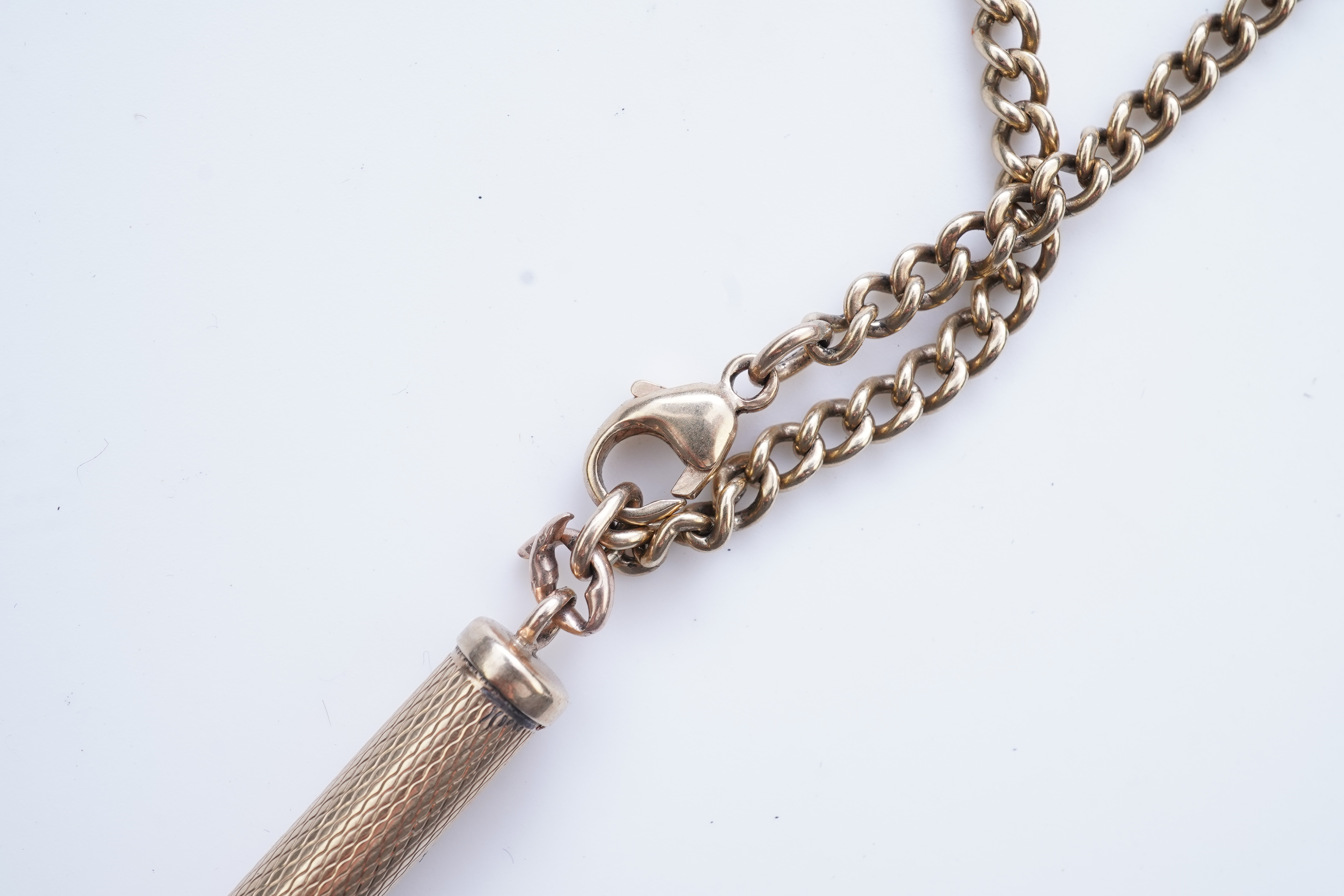 A gold toothpick and chain necklace